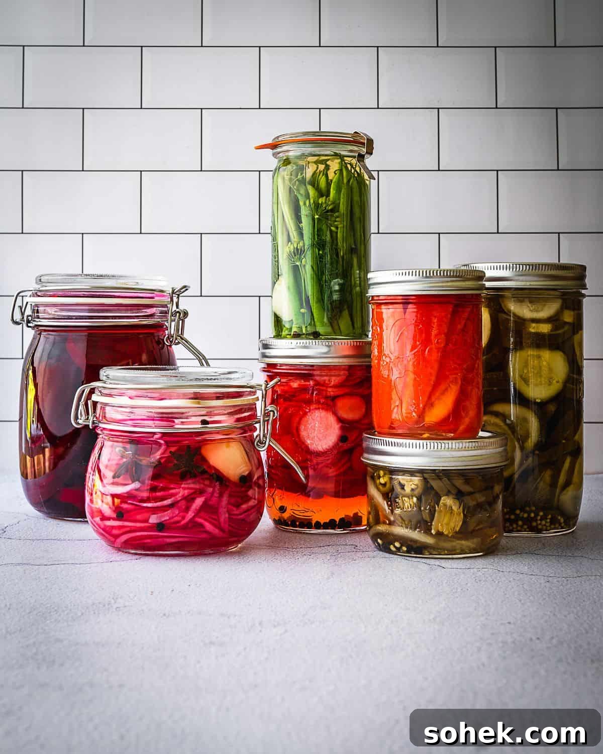 11 Must-Try Summer Pickle Recipes for Fresh, Tangy Flavor 2 Pickle jars on a counter.