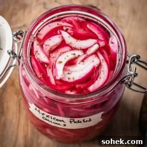 An opened jar of pickled Mexican onions with a label on a wooden board.