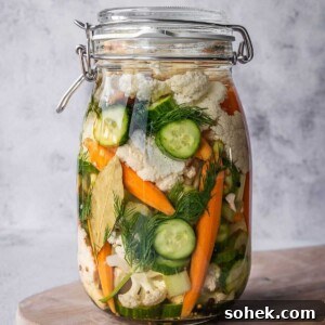 Large pickling crock filled with pickled Italian vegetables, herbs and spices.