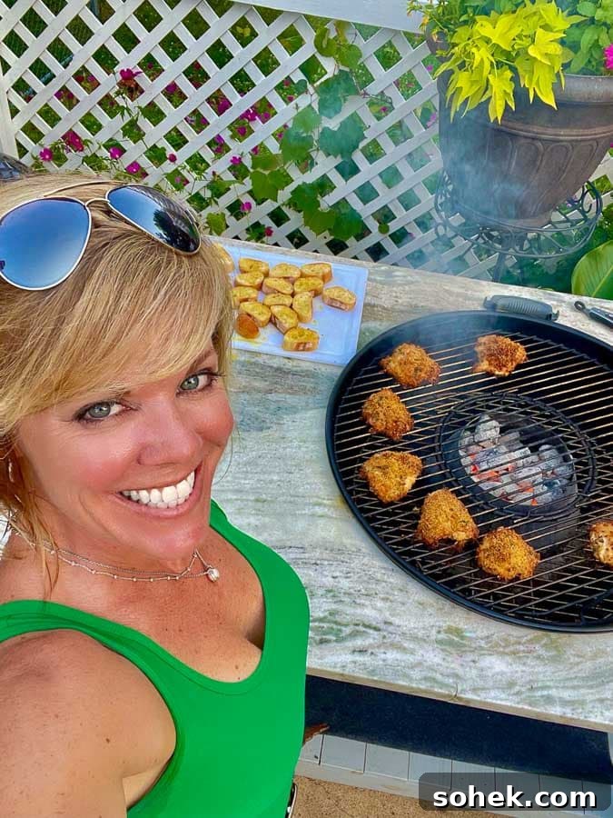 Juicy Grilled Italian Chicken Thighs with Herb Marinade 3 Jennifer grilling Italian chicken thighs on a 26" weber kettle grill