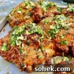 Juicy Grilled Italian Chicken Thighs with Herb Marinade 10 square picture of Grilled Italian Chicken Thighs on metal baking sheet