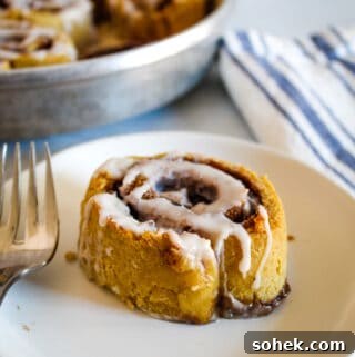 Soft, Gooey Gluten-Free Cinnamon Rolls Made Without Yeast 4 cinnamon roll on a white plate