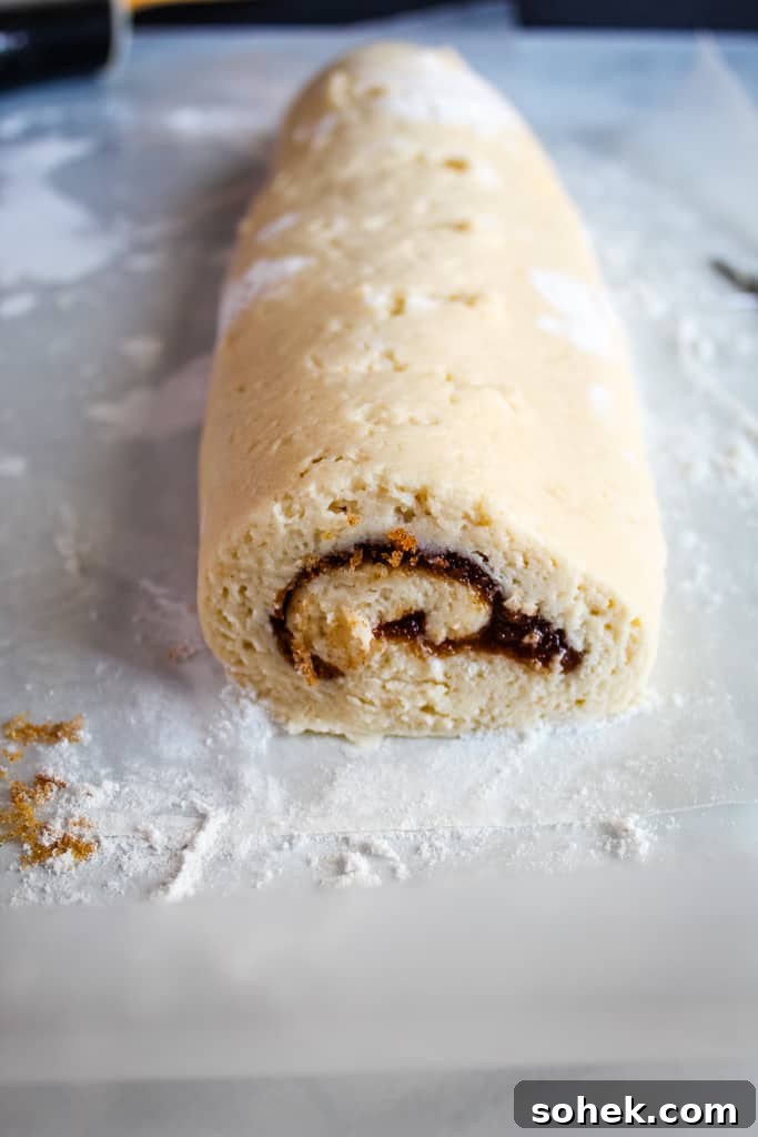 Soft, Gooey Gluten-Free Cinnamon Rolls Made Without Yeast 5 gluten free cinnamon rolls rolled on a white counter