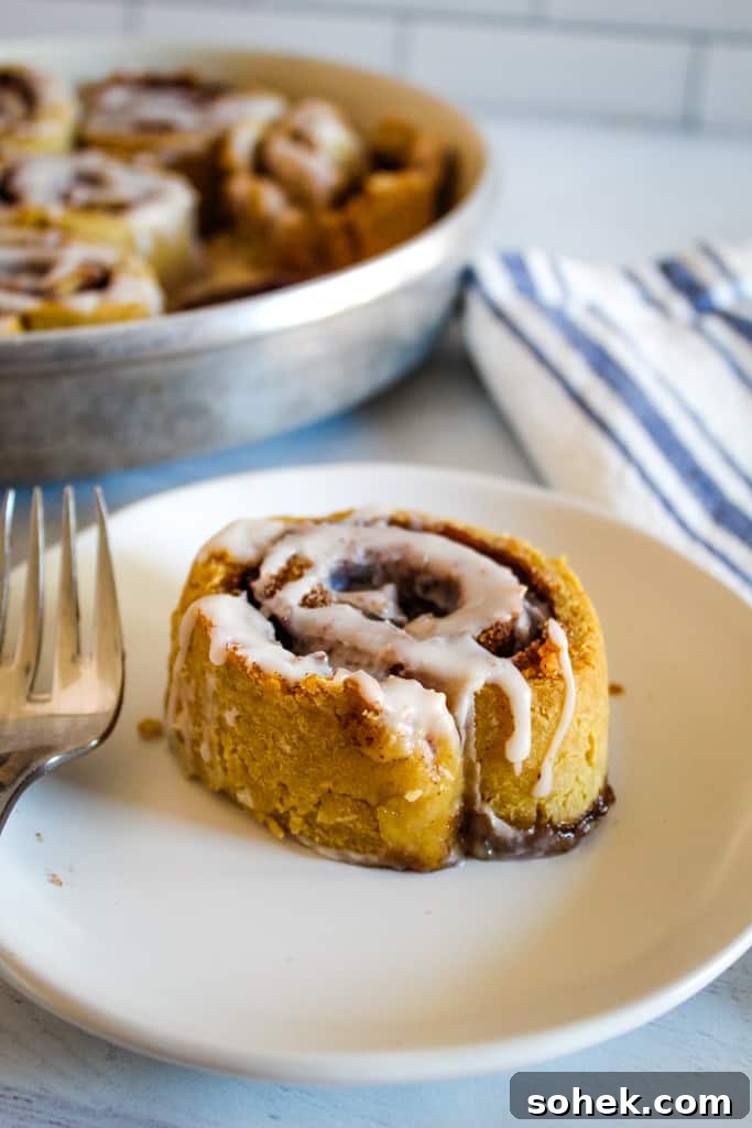 Soft, Gooey Gluten-Free Cinnamon Rolls Made Without Yeast 7 cinnamon roll on a white plate