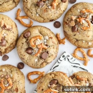 Ultimate Kitchen Sink Cookies Recipe: Loaded Chocolate Chip Bars 10 kitchen sink cookies spread out on a white surface.