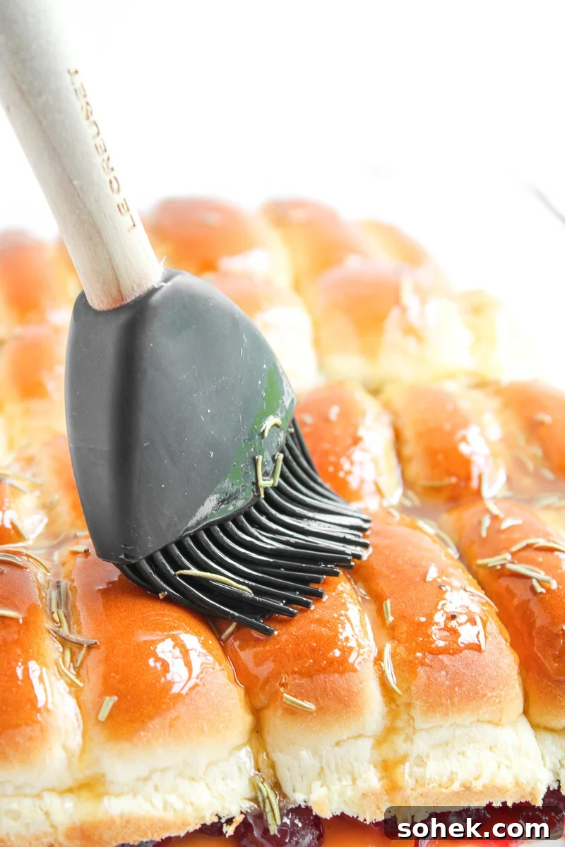 Melted butter mixture is brushed on top of the rolls.
