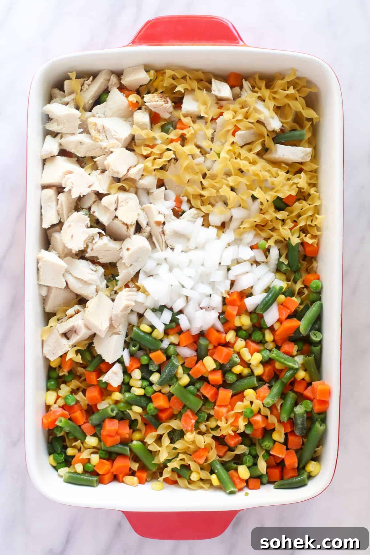 This Creamy Chicken Noodle Casserole is comfort food at its finest! Everything you love about chicken noodle soup, but as a flavor-packed casserole. Enjoy! Ingredients for creamy chicken noodle casserole before being mixed.