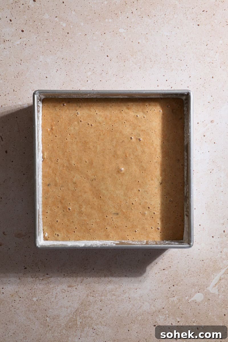 Sourdough Discard Carrot Cake Recipe for Moist, Flavorful Loaf 9 Batter poured into a 9x9-inch baking pan.