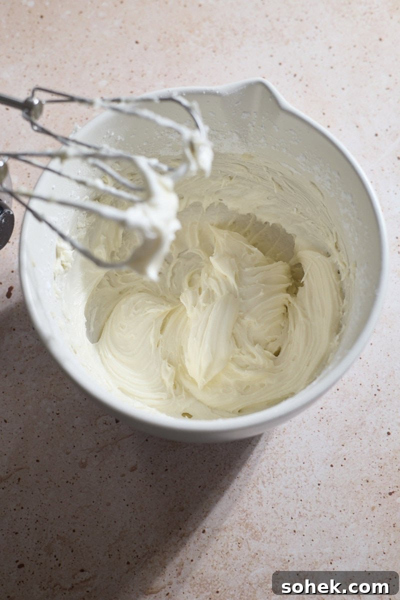 Sourdough Discard Carrot Cake Recipe for Moist, Flavorful Loaf 10 Icing whipped in a white bowl.