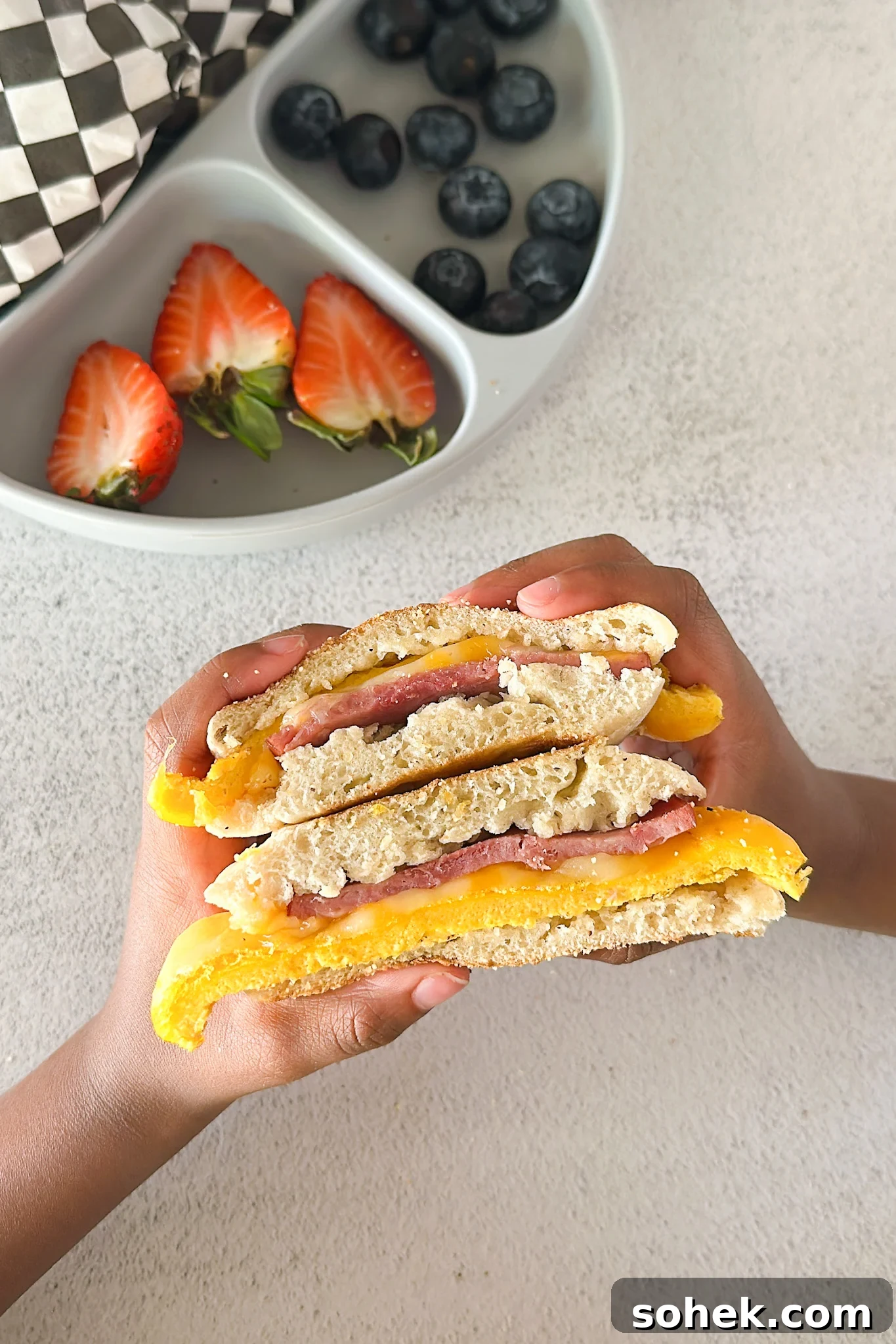 Freezer breakfast sandwich served with berries.