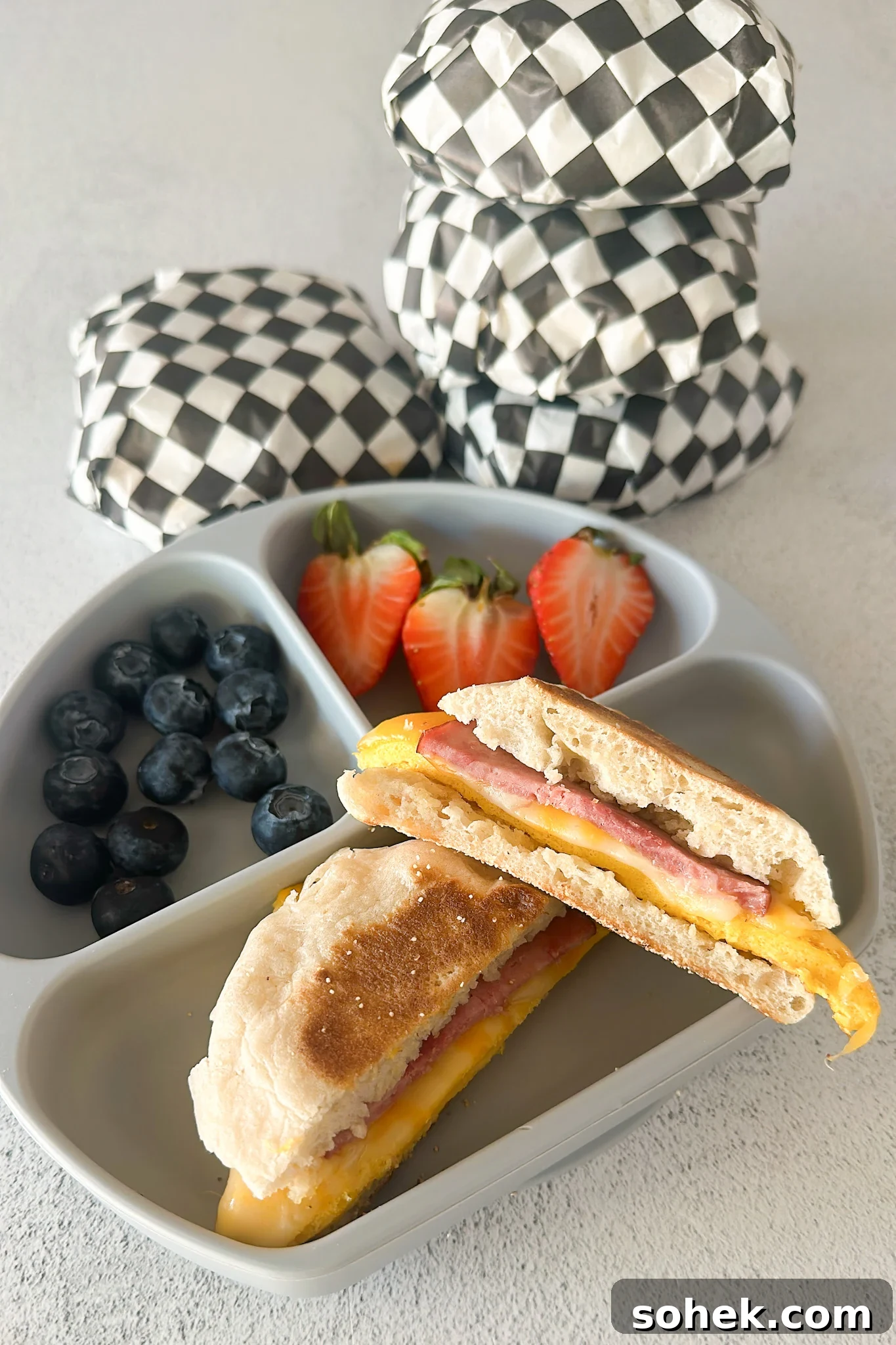 Freezer breakfast sandwich served with berries.