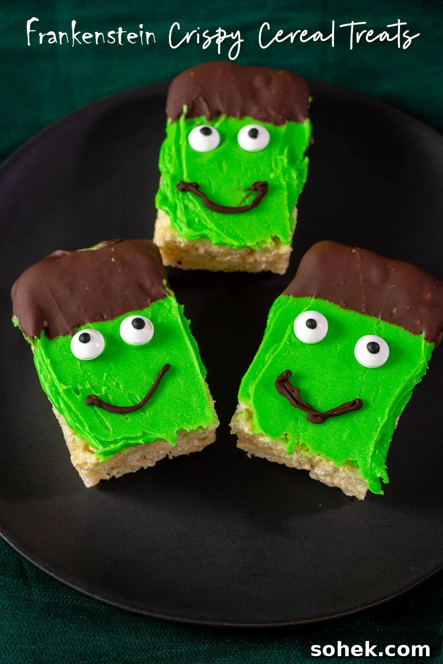 Frankenstein Rice Cereal Treats with Creepy Candy Eyes 4 Three Frankenstein Crispy Rice Cereal Treats on a black plate