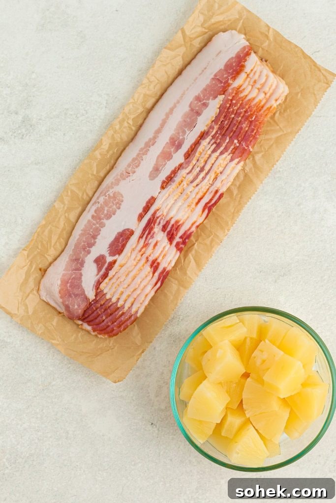 Crispy Air Fryer Bacon-Wrapped Pineapple Bites 3 Bacon and pineapple on a white marble table