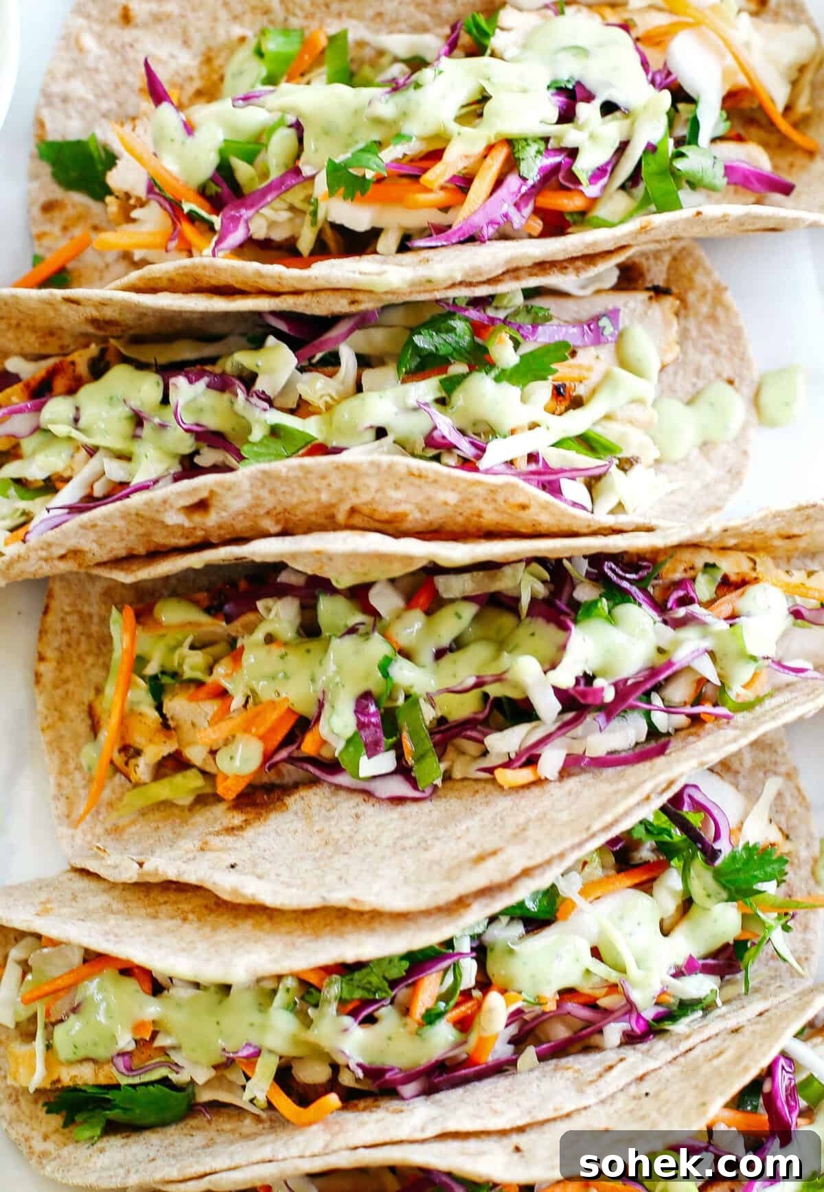 Cilantro Lime Chicken Tacos with coleslaw and avocado crema