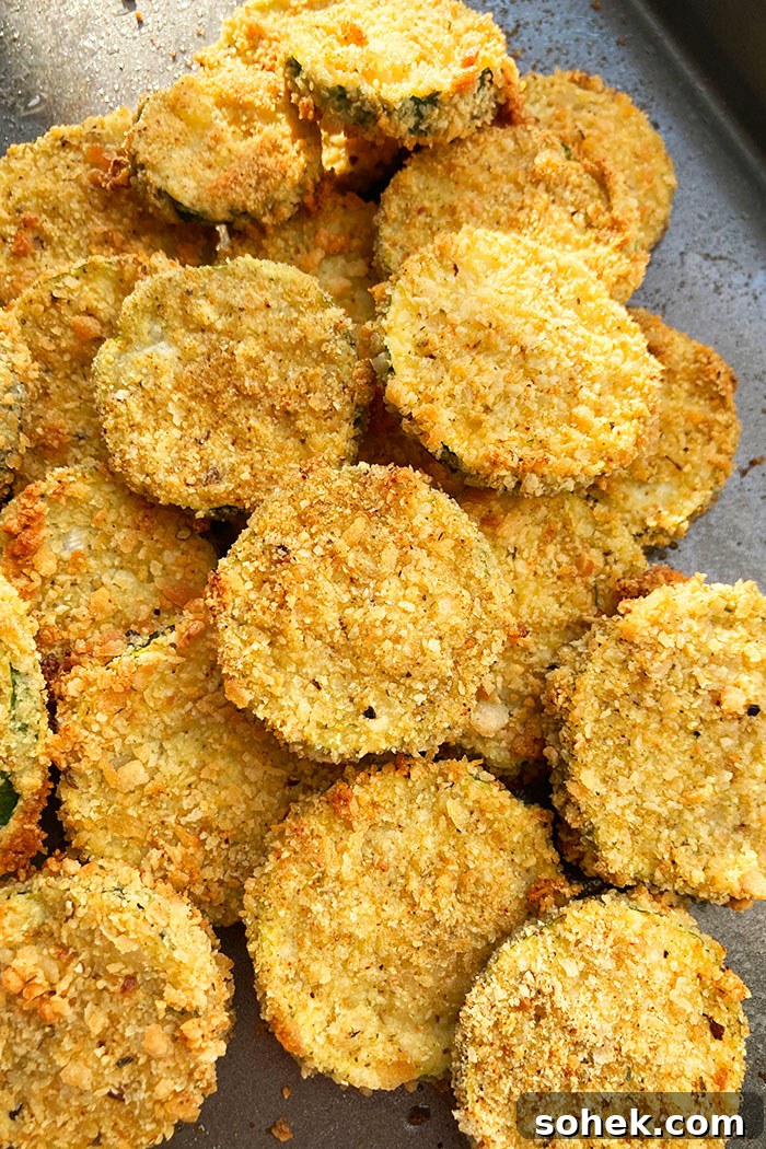 Crispy Oven-Baked Zucchini Chips (One-Pan Recipe) 3 Baking Tray Filled With Crispy Courgette Chips