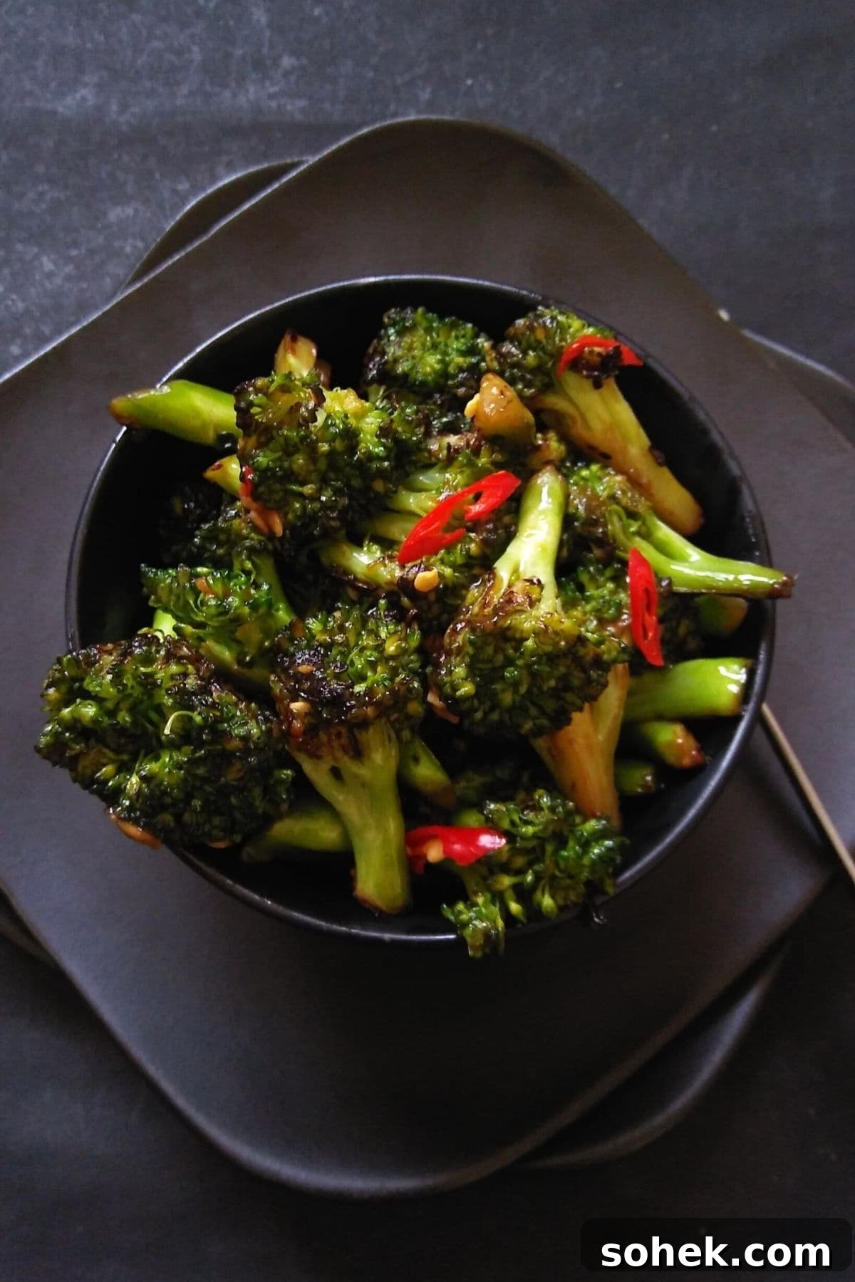 Flavorful Asian Broccoli Stir-Fry with Garlic and Soy Sauce 2 Image showing stir fried broccoli served in a black bowl.