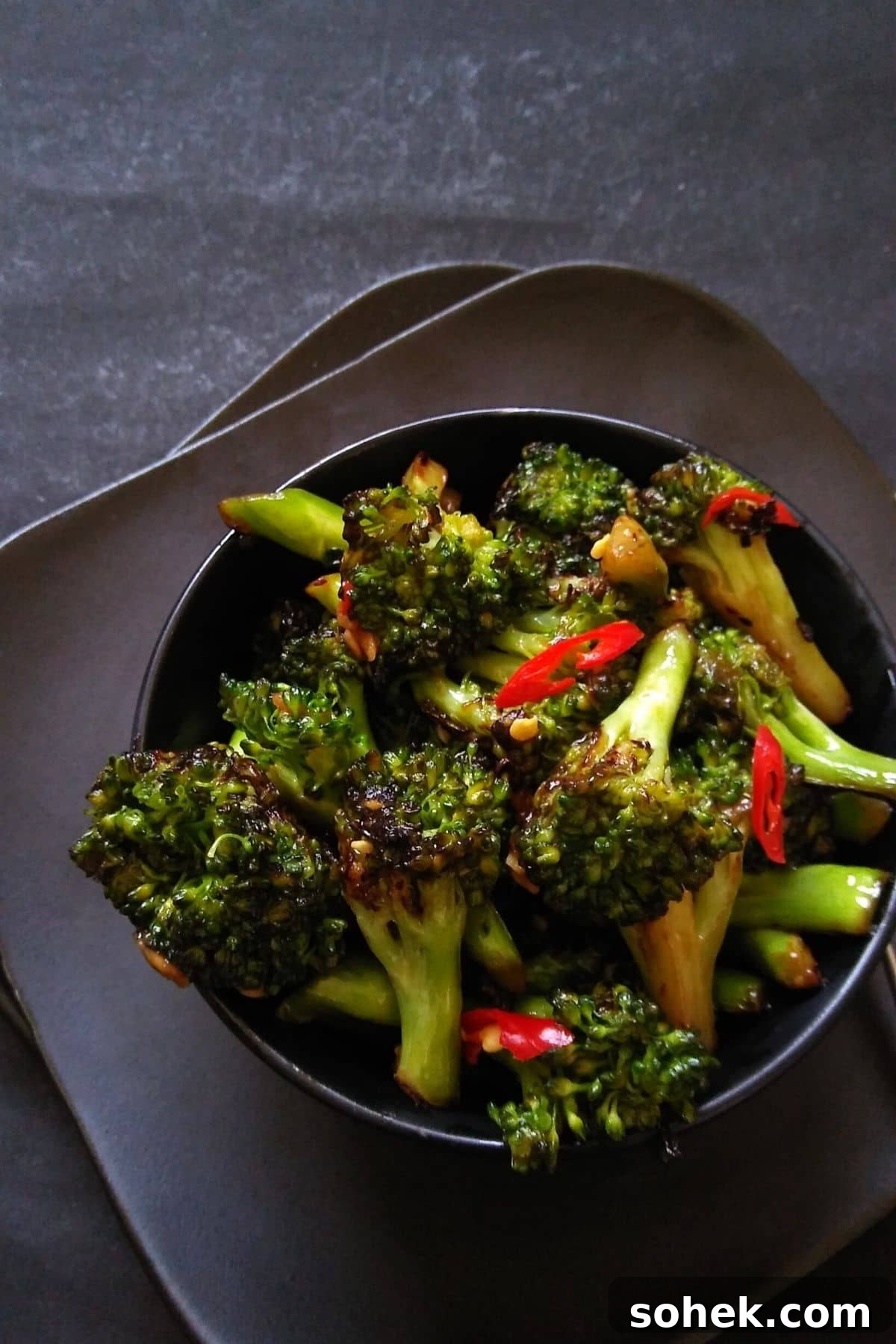 Flavorful Asian Broccoli Stir-Fry with Garlic and Soy Sauce 5 Image showing stir fried broccoli served in a black bowl.
