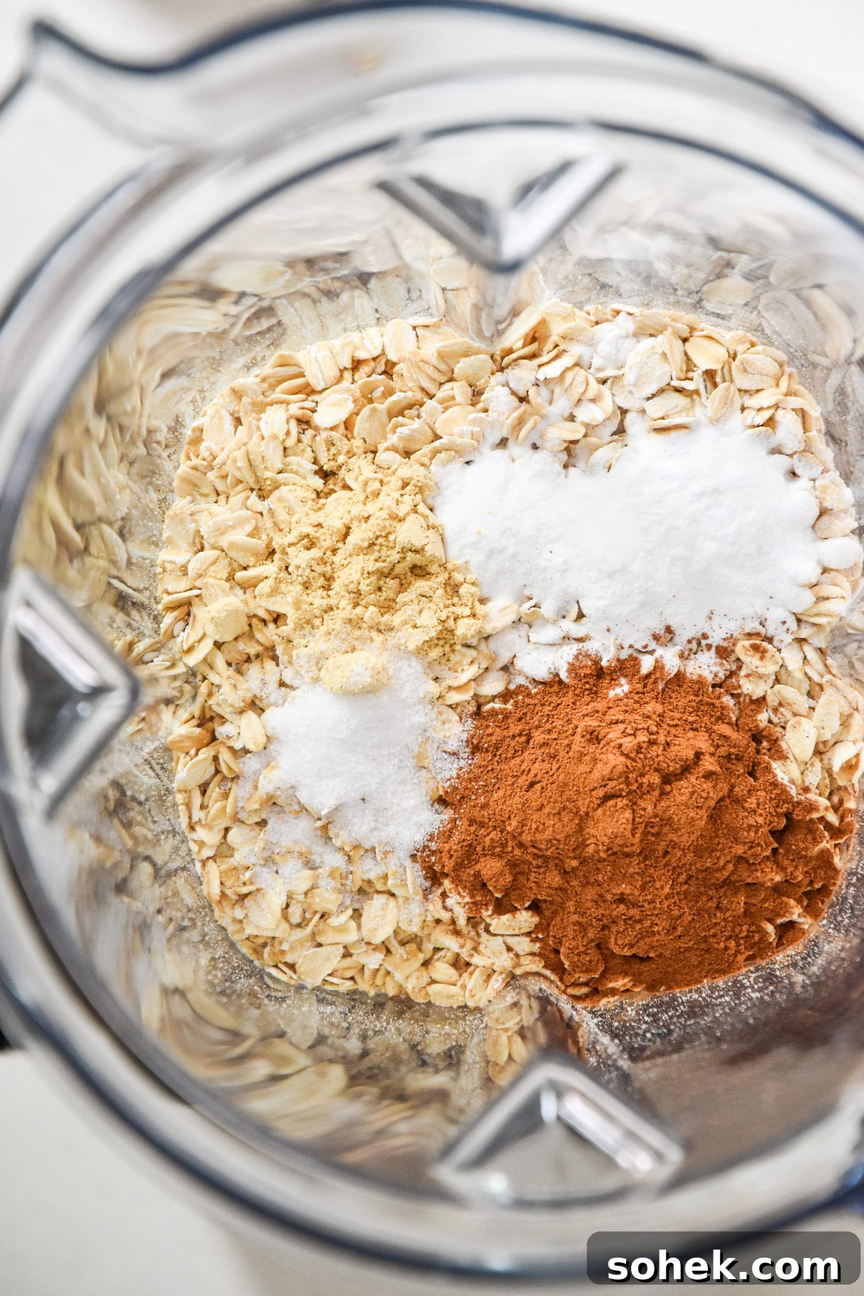 oats cinnamon ginger baking soda and salt about to be blended in a vitamix