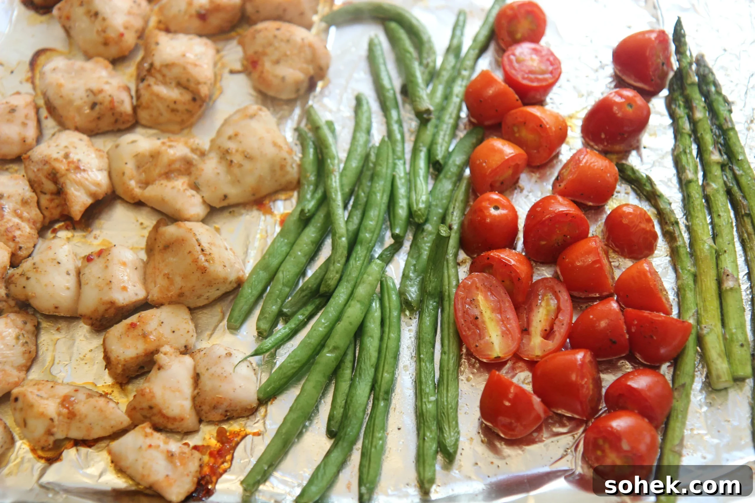 One Pan Chicken and Veggies - Seasoned chicken with green beans, asparagus, and cherry tomatoes.