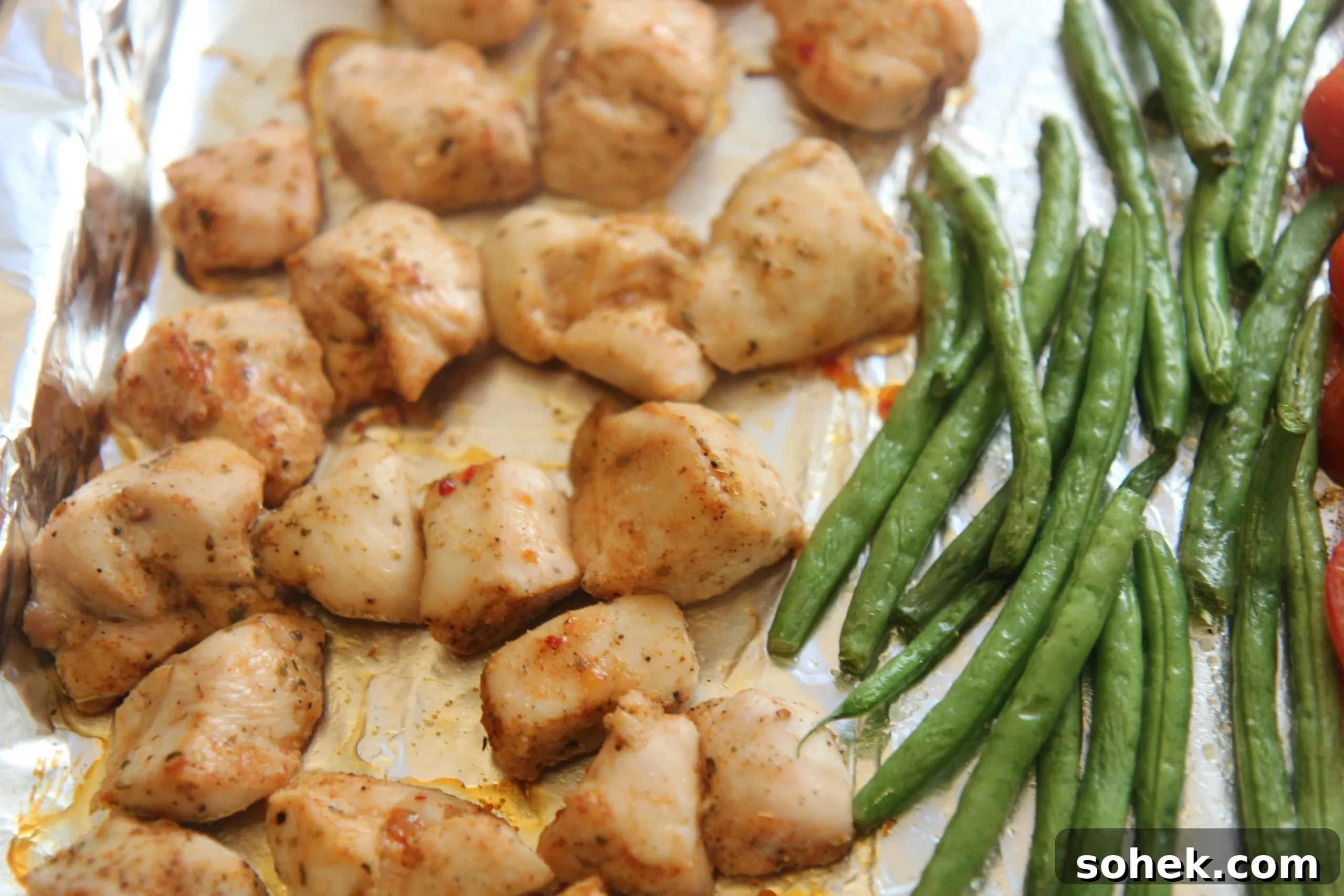Chicken breast chunks and green beans seasoned and baked for a one-pan dinner.