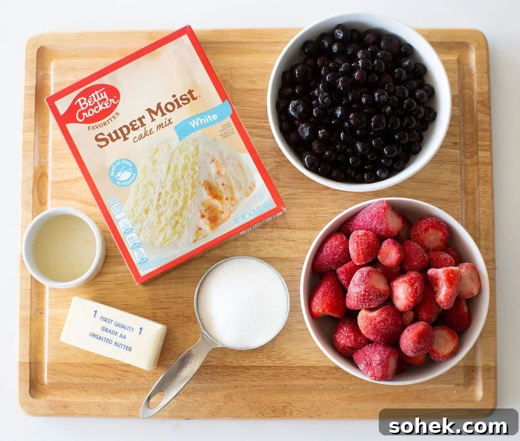 Viral Berry Dump Cake Recipe: Quick No-Fuss Dessert PMID 4 A wooden board displaying ingredients for baking: a box of white cake mix, a bowl of blueberries, a bowl of strawberries, a stick of unsalted butter, a small bowl of liquid, and a measuring cup with sugar.