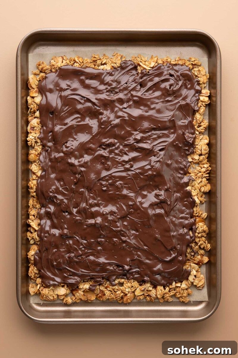 S'mores Granola Bark Recipe — Crunchy Chocolate & Marshmallow Snack 5 granola with a layer of chocolate spread on top