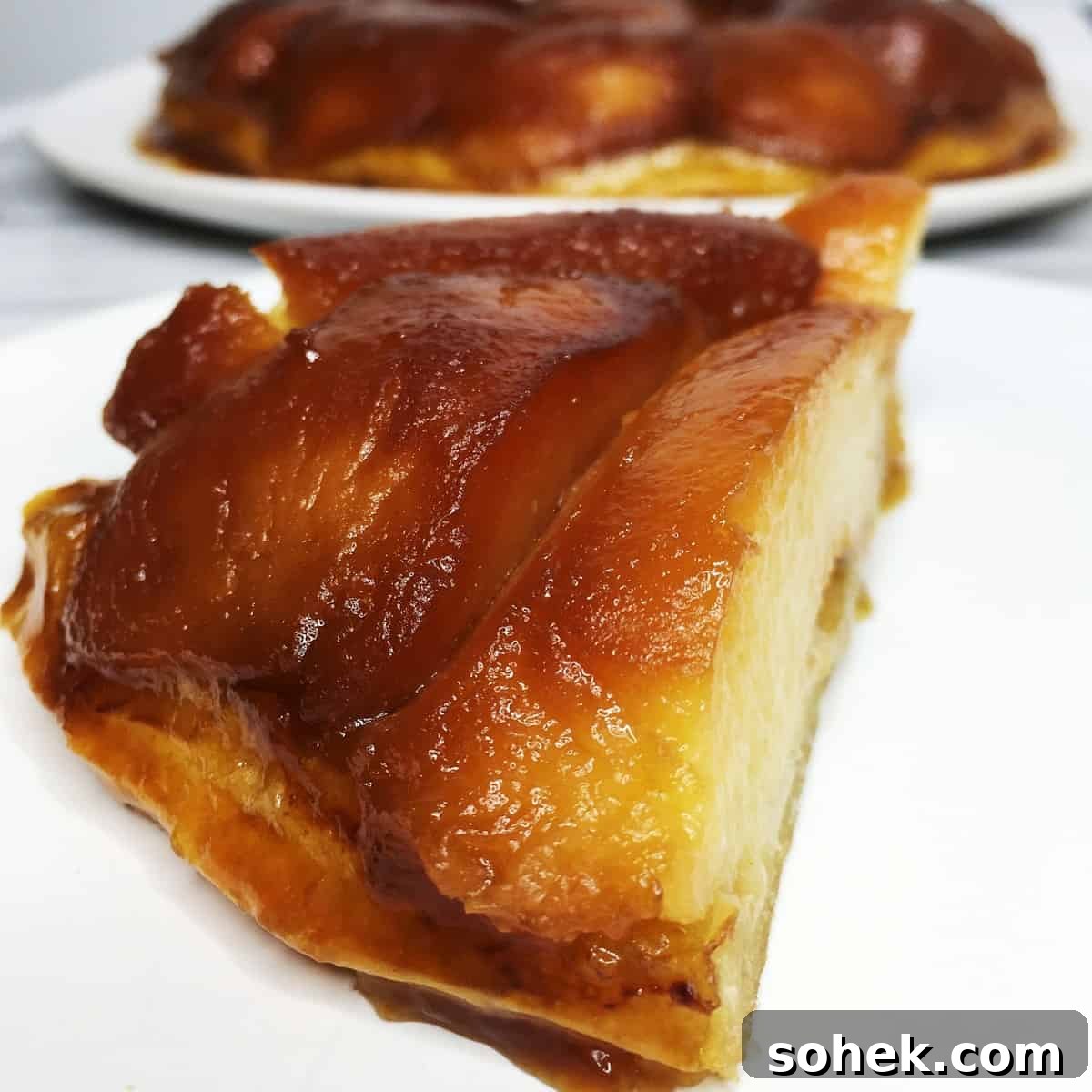 A slice of French quince tarte Tatin with the rest of the dessert in the background.