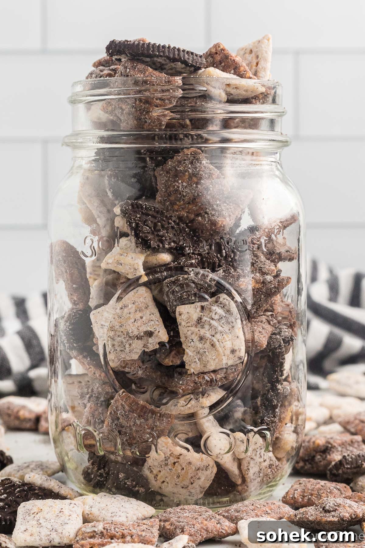 Oreo Puppy Chow Recipe: No-Bake Chocolate Cookie Snack 12 Oreo Puppy Chow in glass jar.