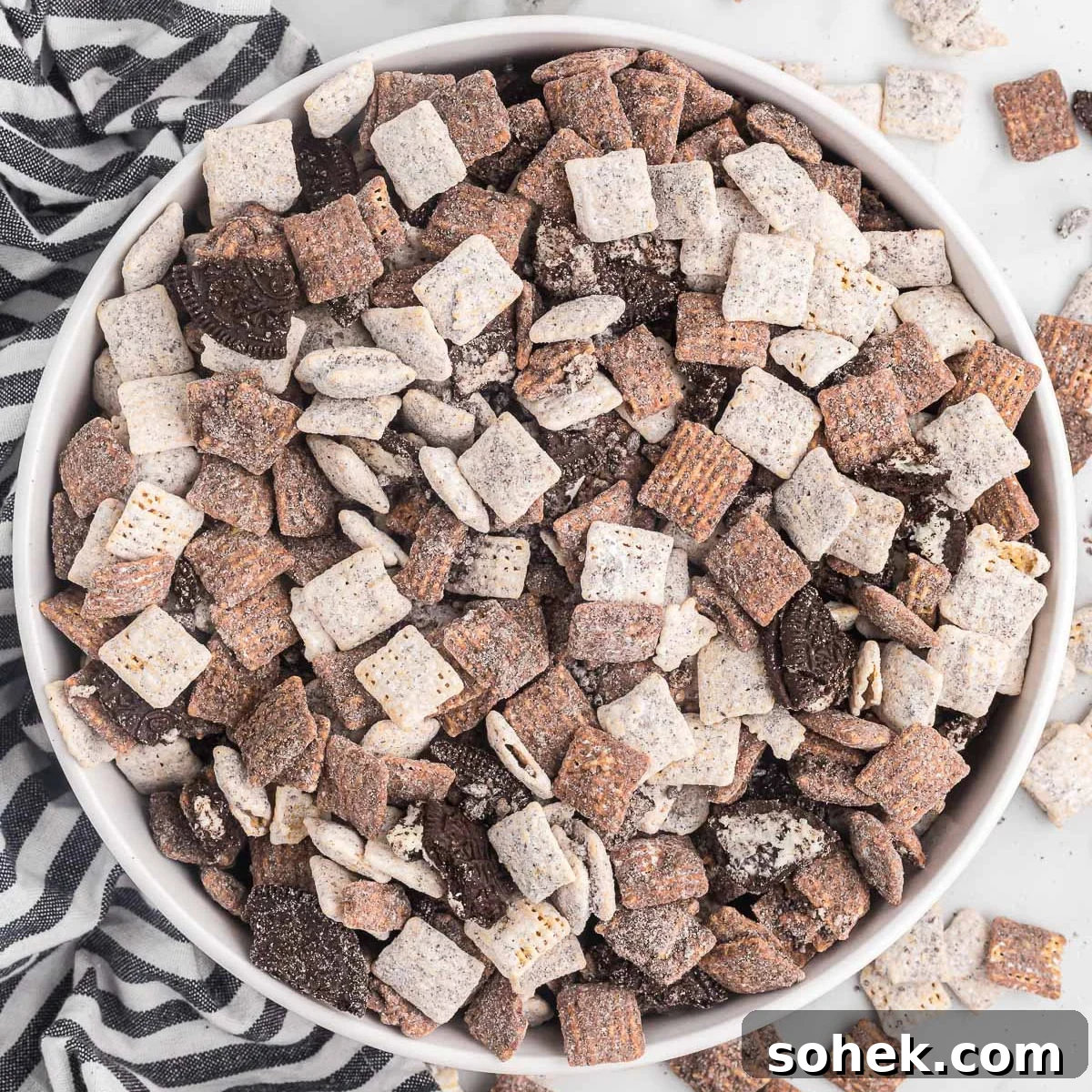 Oreo Puppy Chow Recipe: No-Bake Chocolate Cookie Snack 13 Cookies and cream muddy buddies in a white bowl.