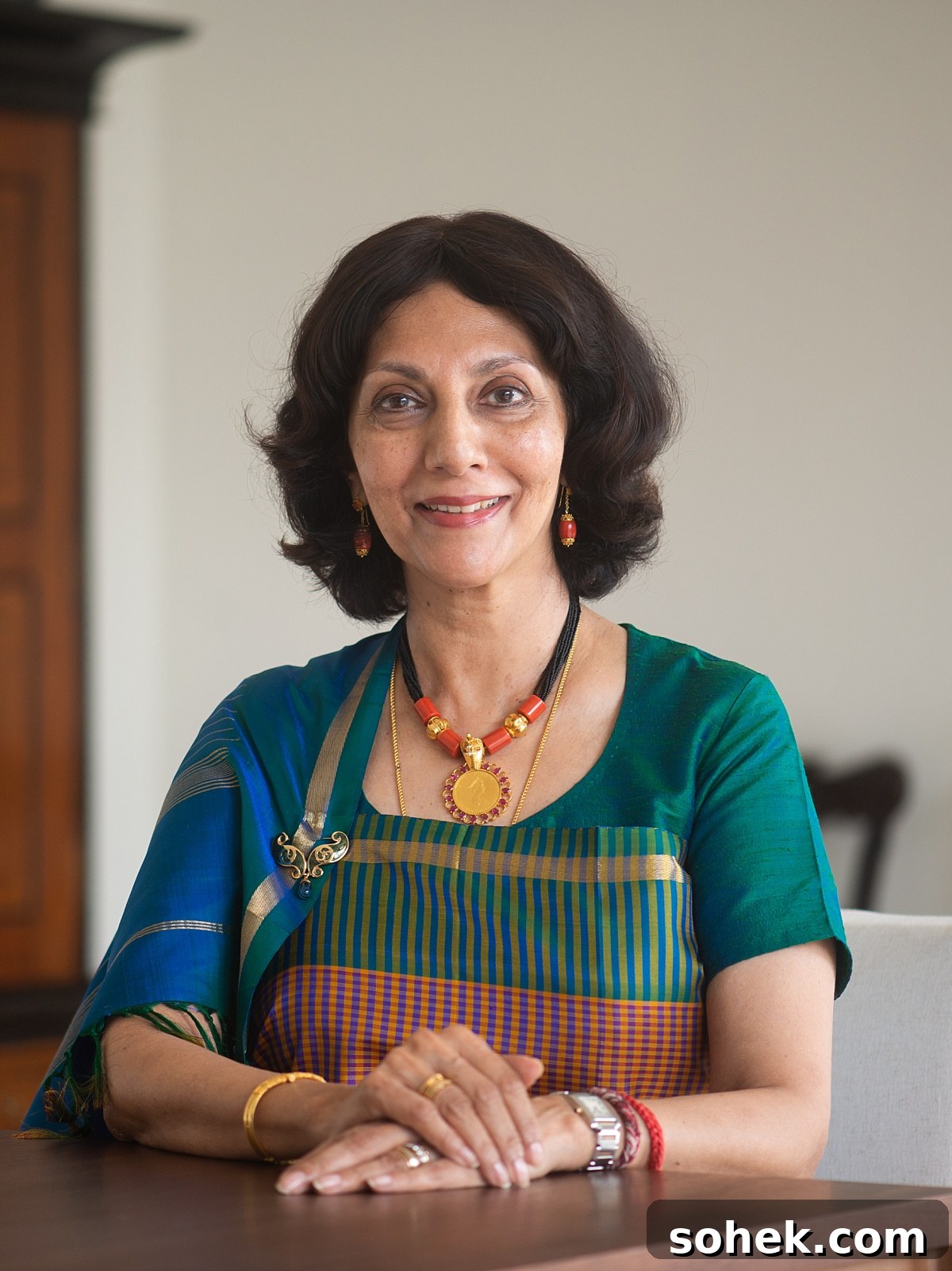 Creamy Kodava Mushroom Curry with Coconut Milk — Vegan Recipe 8 kaveri ponnapa author of the vanishing kodavas in a teal, royal blue, red, and gold sar