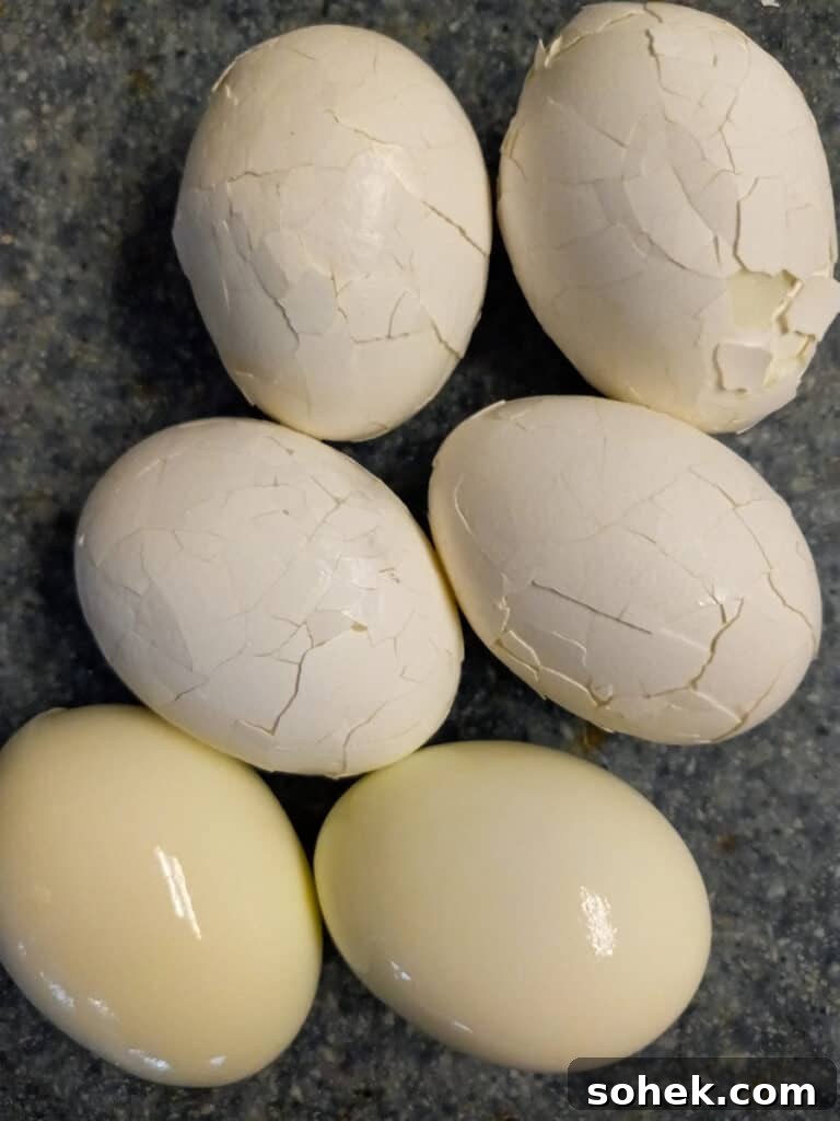 Authentic Amish Pickled Eggs and Beets Recipe for Tangy Flavor 5 crushing shells and peeling hard-boiled eggs.