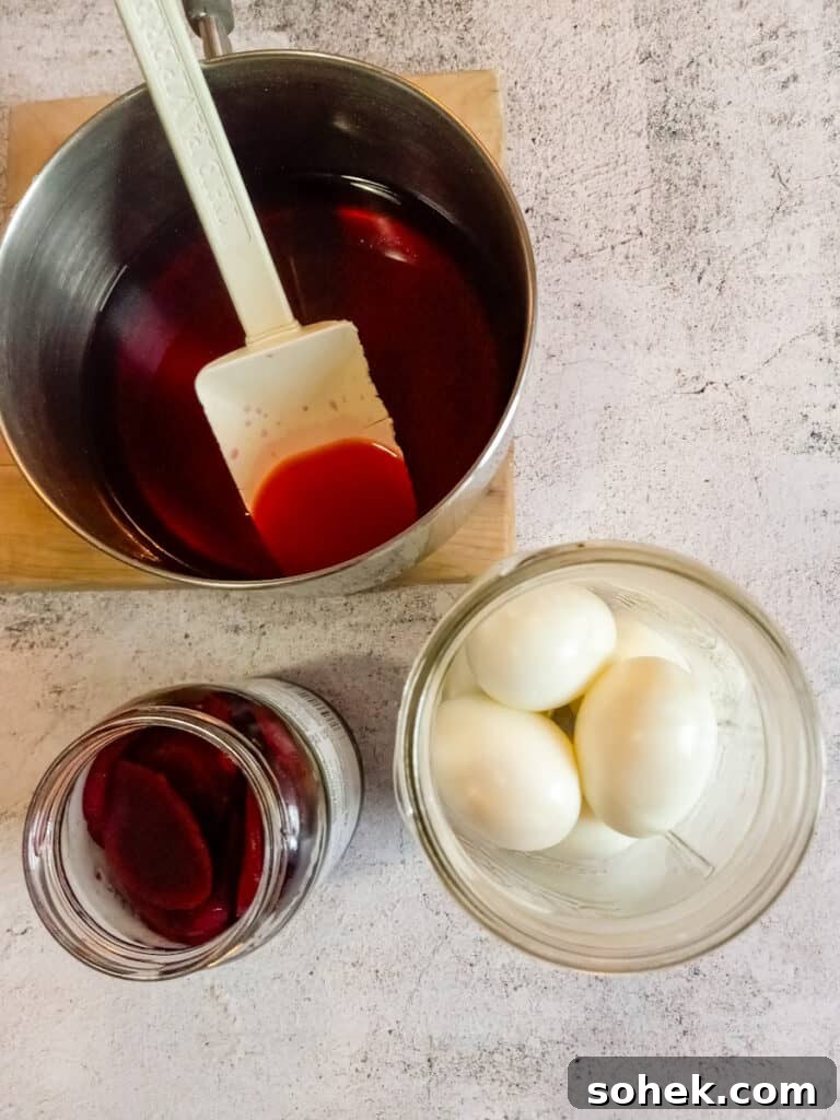 Authentic Amish Pickled Eggs and Beets Recipe for Tangy Flavor 7 pickling brine in a saucepan, boiled eggs in a jar, and pickled beets in another jar.
