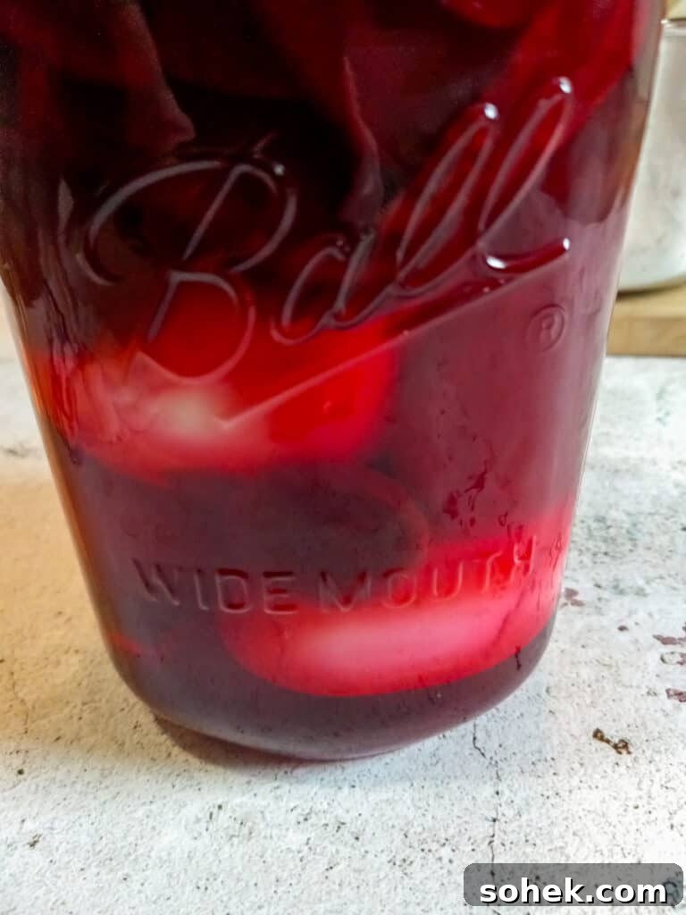 Authentic Amish Pickled Eggs and Beets Recipe for Tangy Flavor 9 a jar with red beet eggs ready to refrigerate.
