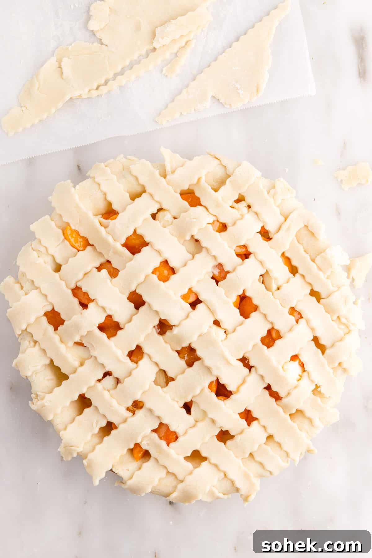 Prepared lattice crust over apricot pie.