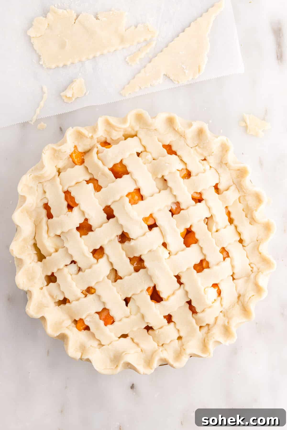 Fluted edges of crust around apricot pie.