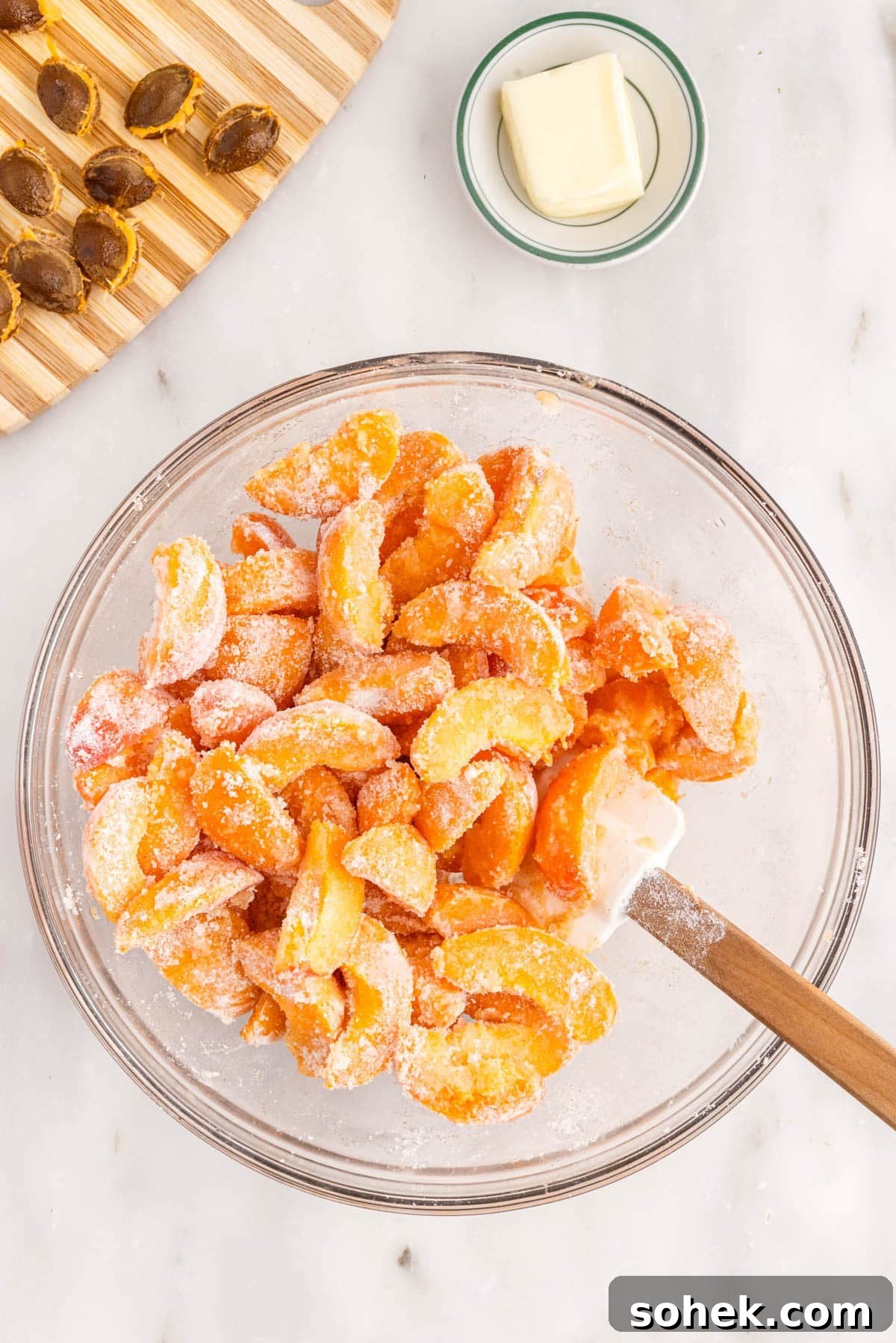 Apricot pie filling stirred together in a glass bowl.