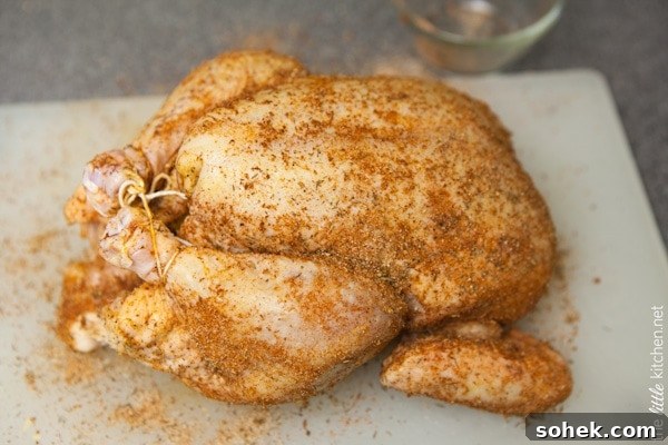 whole chicken tied with kitchen twine on a cutting board