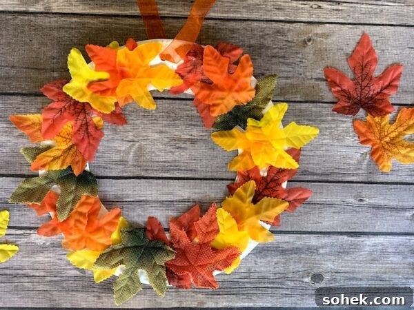 12 Fun Fall Crafts for Kids to Make at Home 15 wreath made from leaves and paper plate