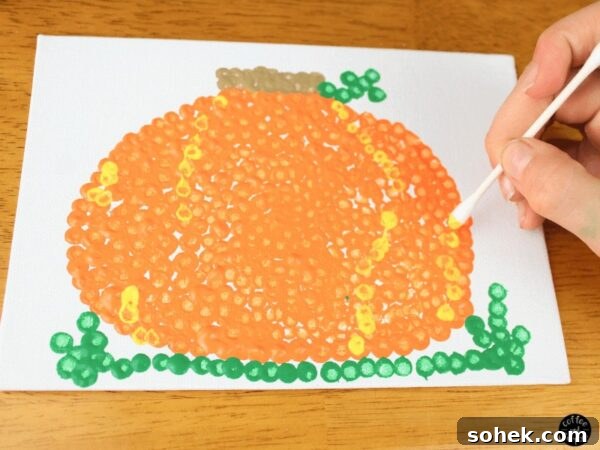 12 Fun Fall Crafts for Kids to Make at Home 5 Pumpkin art made with qtips