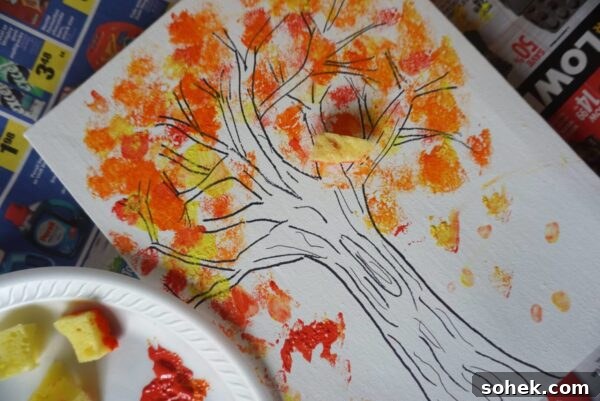 12 Fun Fall Crafts for Kids to Make at Home 7 fall tree with fingerpainted colorful leaves