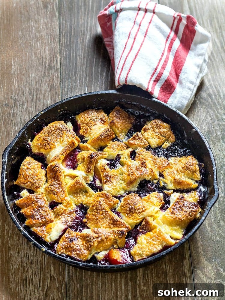 Cast iron pan with baked blueberry peach pandowdy.