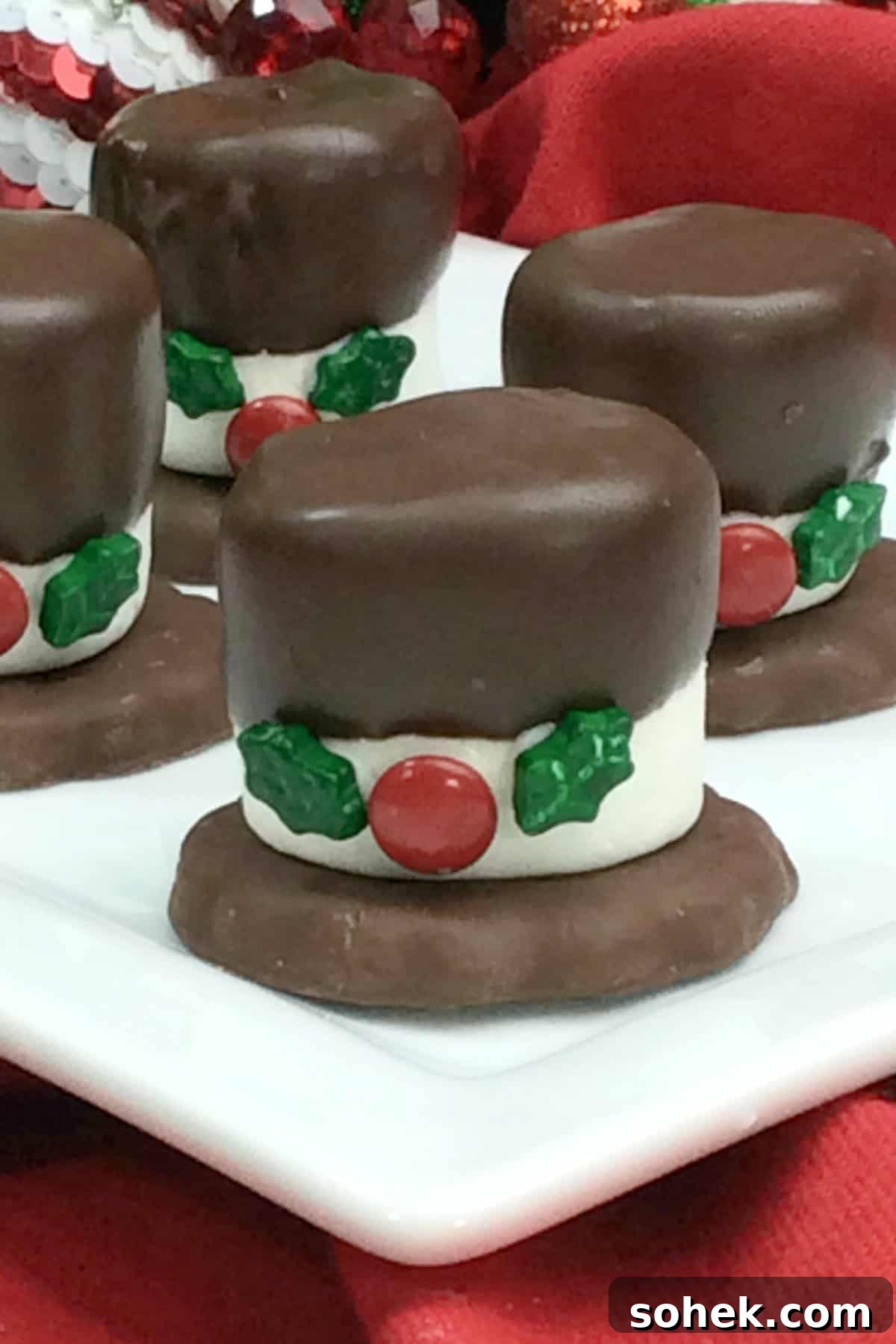These Snowman Hat Cookies are such a fun Christmas treat to make with or for kids using just 5-ingredients including Grasshopper cookies, chocolate and assorted candies! Snowman Hat Cookies on a white platter