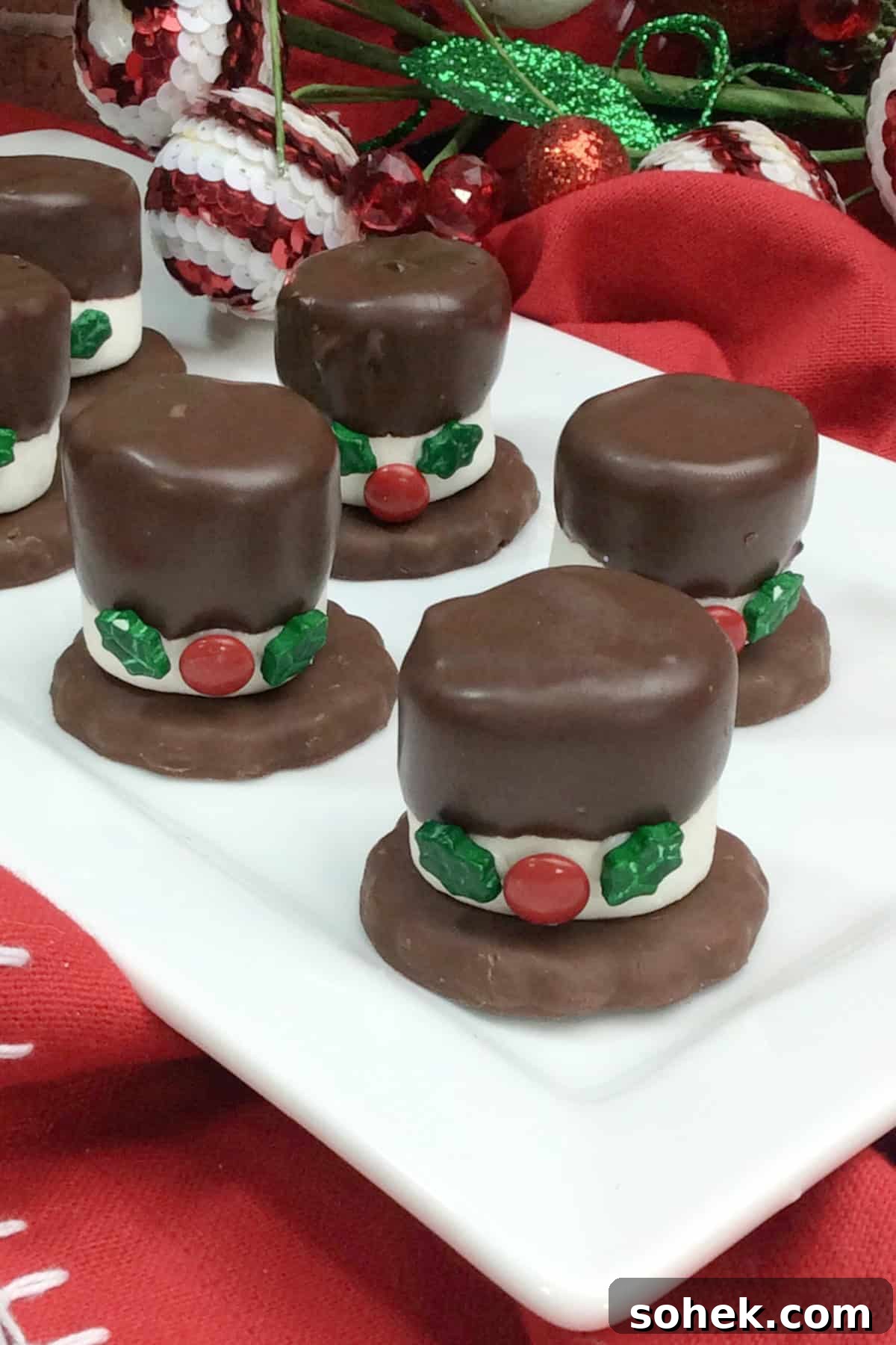 These Snowman Hat Cookies are such a fun Christmas treat to make with or for kids using just 5-ingredients including Grasshopper cookies, chocolate and assorted candies! top view of Snowman Hat Cookies on a platter