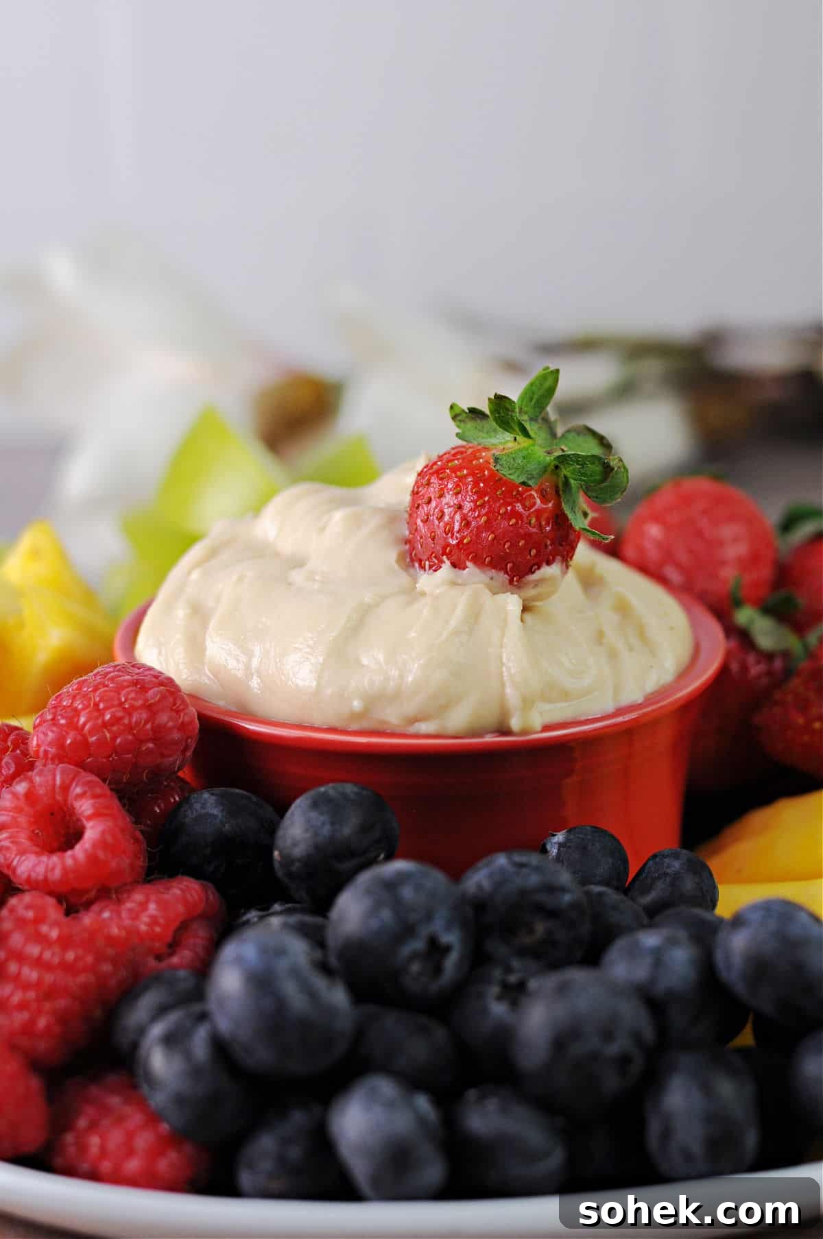 Cream Cheese Fruit Dip: 3-Ingredient Recipe for Parties 2 Cream cheese fruit dip surrounded by a platter of fruit.