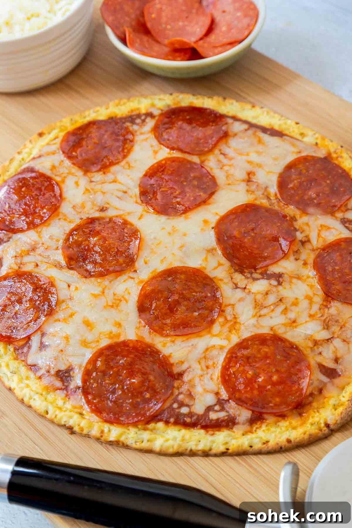 Cottage Cheese Pizza Crust Recipe: Thin, Chewy Low-Carb Base 2 A cooked pepperoni pizza on a cutting board.