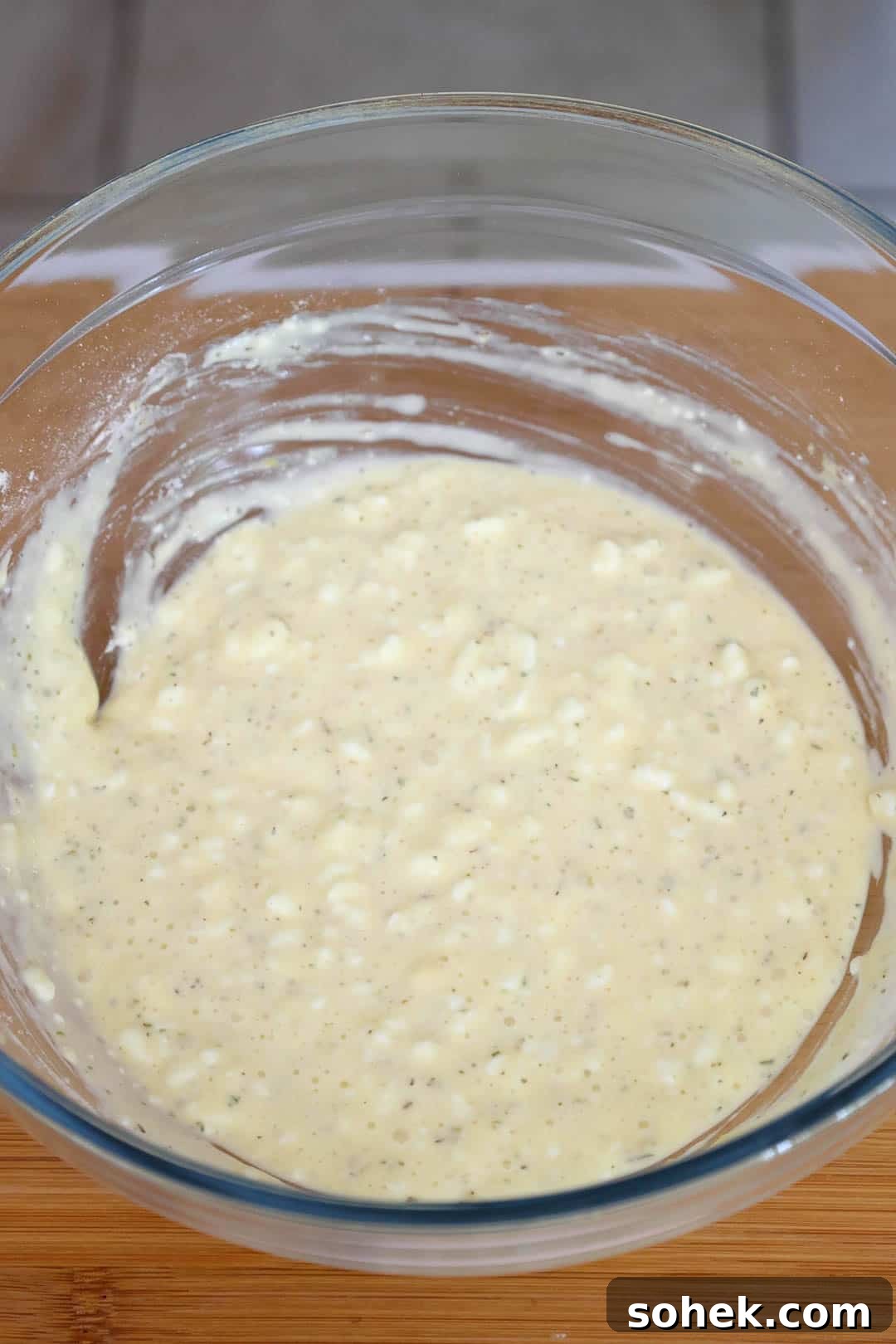 Cottage Cheese Pizza Crust Recipe: Thin, Chewy Low-Carb Base 5 A glass bowl with uncooked pizza crust batter.