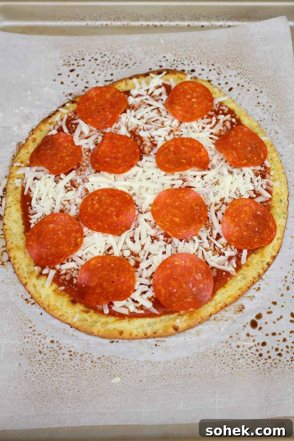 Cottage Cheese Pizza Crust Recipe: Thin, Chewy Low-Carb Base 9 An unbaked pizza with sauce, shredded cheese, and pepperoni slices on top.