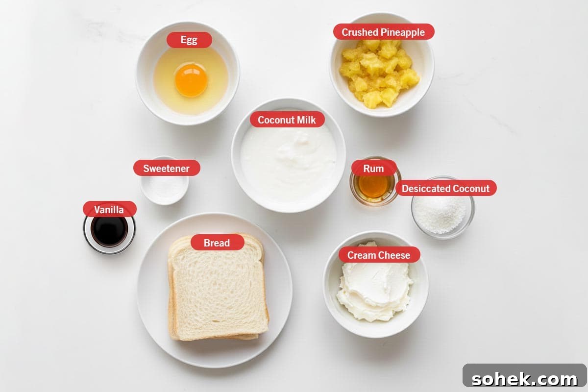 Pineapple Coconut French Toast Recipe — Piña Colada Flavor 3 Top shot of ingredients: egg, crushed pineapple, coconut milk, rum, dessicated coconut, cream cheese, bread, sweetener, and vanilla.