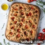Tomato and Olive Focaccia Recipe with BBC Maestro Review 15 Tomato olive focaccia surrounded by herbs, tomatoes and bowls of olives, salt and olive oil.