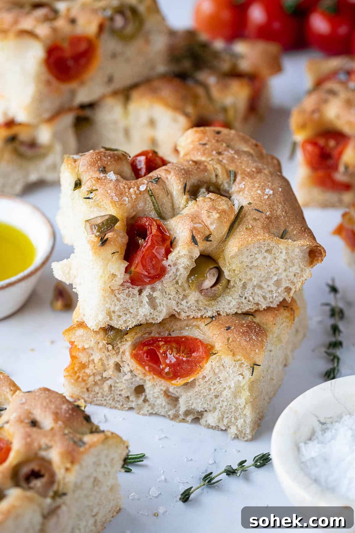 Tomato and Olive Focaccia Recipe with BBC Maestro Review 3 Close up of slices of tomato and olive focaccia.